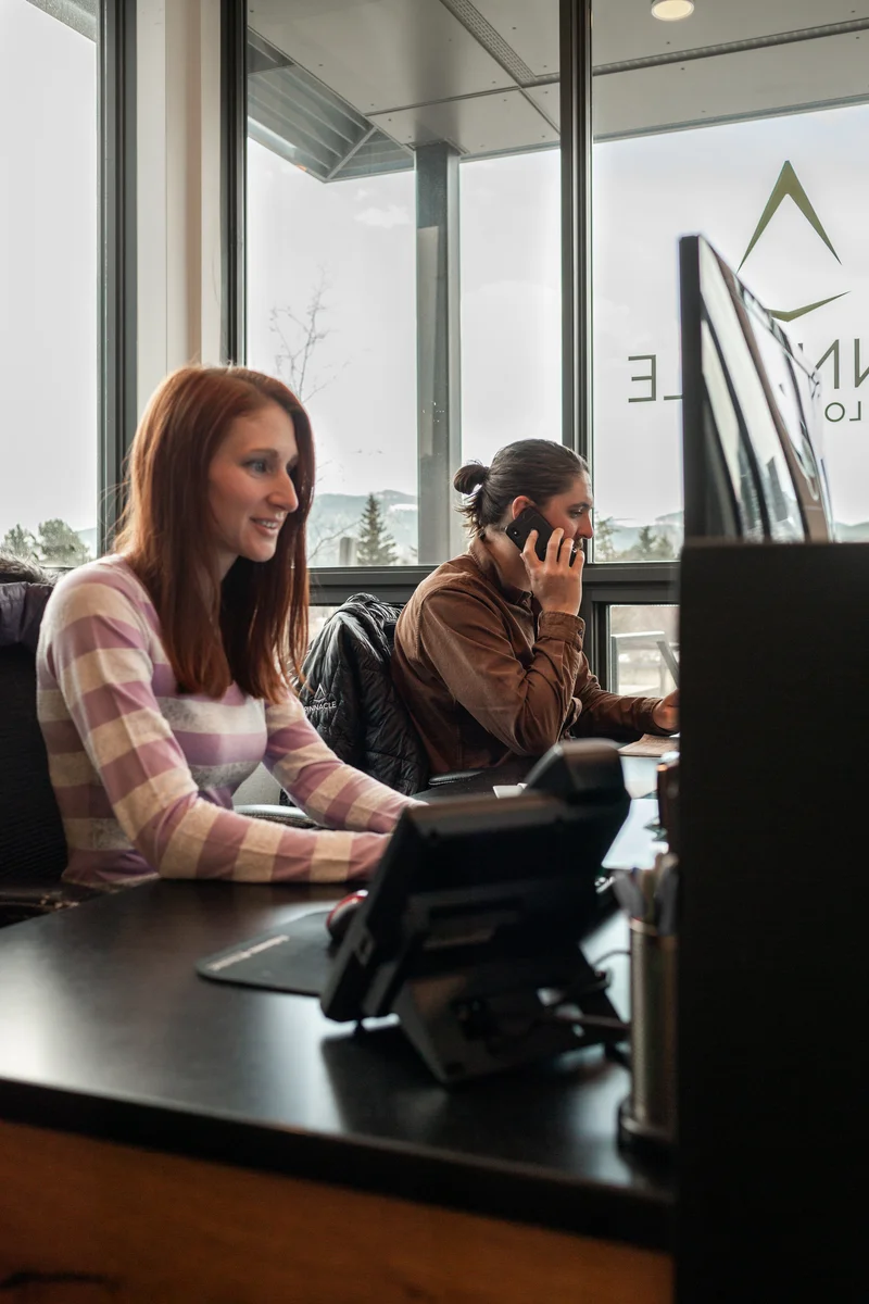 Pinnacle Lodging front desk team assisting guests